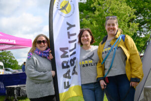 A picture of three ladies smiling towards the camera.